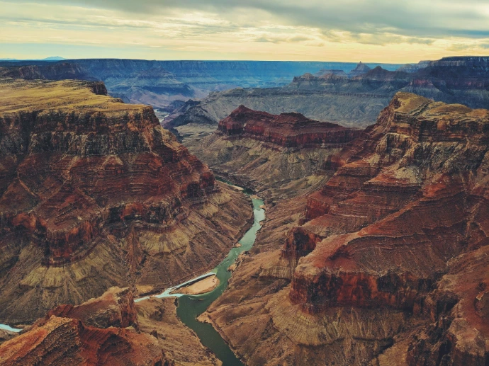 The Colorado River winding through the deep red rock canyons of the Grand Canyon